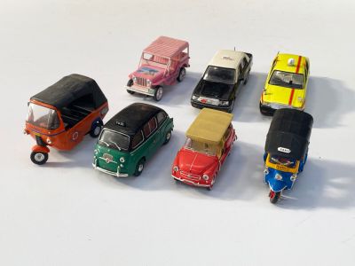 plusieurs petites voitures sont alignées sur une surface blanche