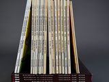 books stacked on top of each other in a wooden holder