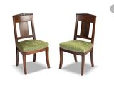 two wooden chairs with green upholstered seats on a white background