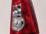 a close up of a red tail light on a white surface