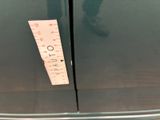 a measuring tape on the side of a green refrigerator