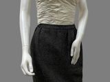 female mannequin wearing a black and white dress with a beige top