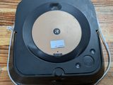 a black record player sitting on top of a wooden table