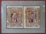 two framed pictures of a couple of paintings on display in a glass case
