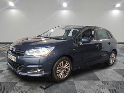 a blue car is parked on a checkered floor in a garage