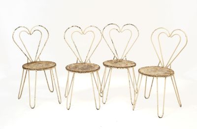 four chairs with hearts on them sitting on a white surface