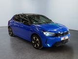the blue car is parked in a large room with a gray floor