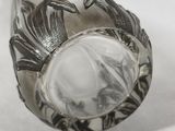 a silver ring with a stone in it on a white surface