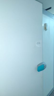 a bathroom with a toilet and a shower stall in it