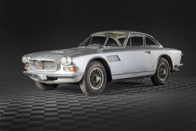 an image of a classic car on a black and white checkered floor