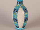 a blue and white vase sitting on a table
