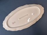 a white plate with a lid on a blue table
