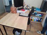 a person standing at a desk with a laptop on it