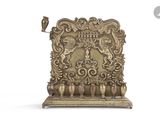 a gold plate with a bird on top of it
