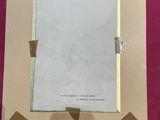 a picture of a person holding up a picture frame