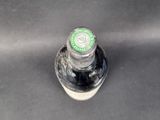 a close up of a bottle of beer on a table