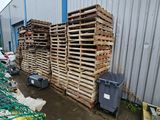 a lot of crates that are stacked on the side of a building