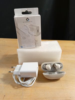 une boîte d'écouteurs et un chargeur posés sur une table