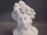a statue of a woman with flowers on her head