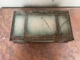 a glass box on the floor with a handle on it