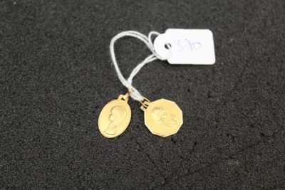 a close up of a pair of earrings with a tag on them