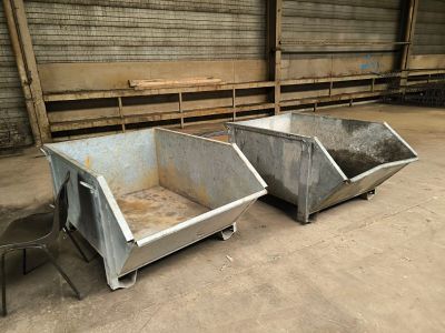 two bins that are sitting in the middle of the floor