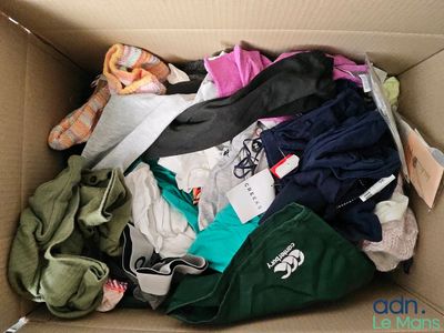 a cardboard box filled with clothes and a pair of shoes
