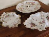 three plates and a bowl on a wooden table