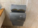 a toilet and a paper dispenser in a bathroom