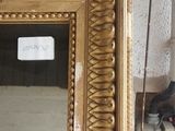a mirror that is sitting on the floor in front of a wall