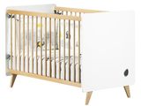 un lit de bébé blanc recouvert d'un drap blanc
