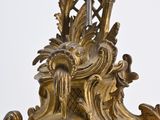a gold clock that is sitting on top of a table