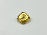 a close up of a gold ring on a white surface