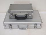 a silver suitcase sitting on top of a white table