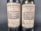 two bottles of wine sitting next to each other on a table