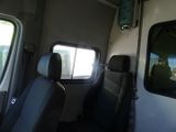 two seats in the back of a bus with a window open