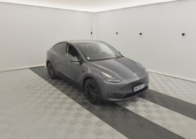 the car is parked in the garage on the checkered floor