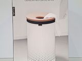the box of a white and black trash can sitting on a table