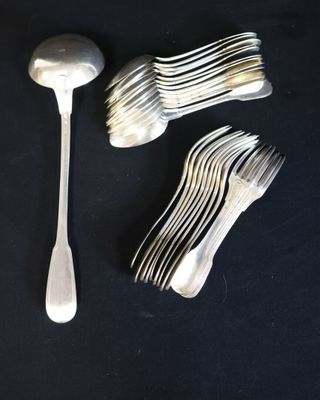 a lot of forks and spoons sitting on a table