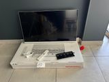 a laptop computer sitting on top of a box on the floor