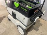 a green and black cleaning machine with a hose on it