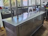 plan de travail en acier inoxydable dans une cuisine professionnelle avec un sol carrelé