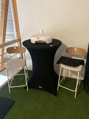 a black table with two chairs next to a ladder