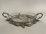 a silver plate with two spoons in it on a table