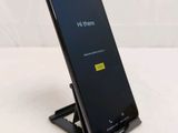 a phone that is sitting on a stand on a table