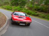 a red car that is driving down the road