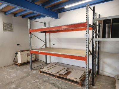 a room that has a shelf and some pallets in it