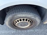 a close up of a flat tire on a white car