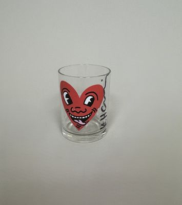 a shot glass with a red heart on it