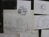 several sketches of a man sitting on a floor next to a pile of papers